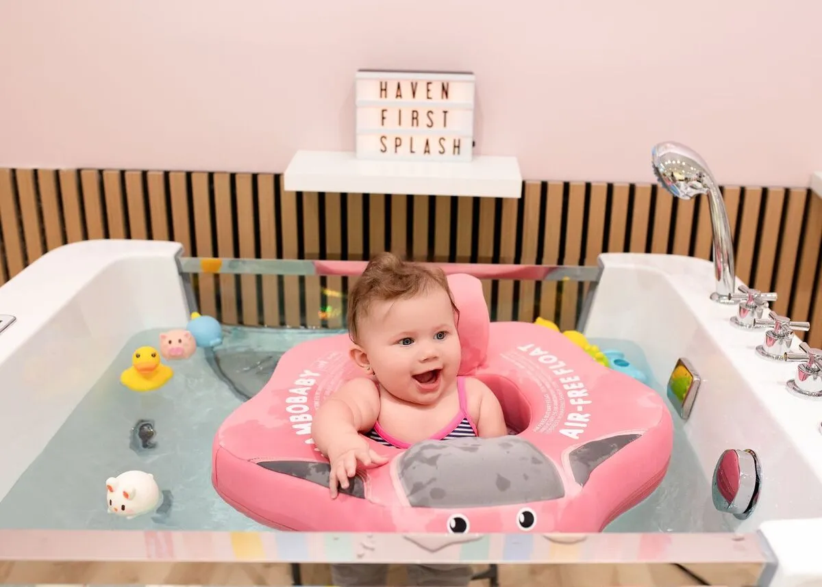 Baby floating in a warm fresh-water tub at Dolphin Dive Baby Spa, London Ontario